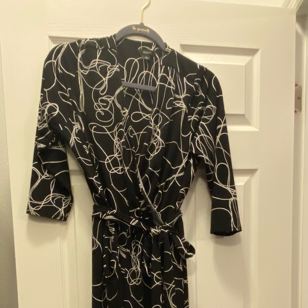 Black and white designed jumpsuit. Cross front with belt.
